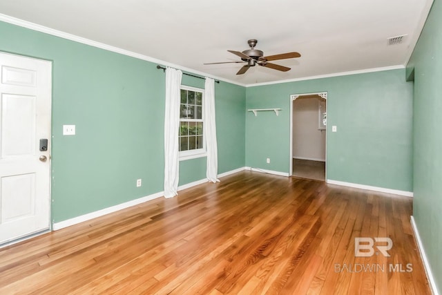 unfurnished room featuring ornamental molding, wood-type flooring, and ceiling fan