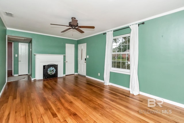 unfurnished living room featuring ceiling fan, dark hardwood / wood-style floors, and ornamental molding