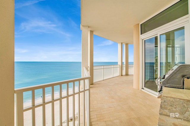 balcony with a view of the beach and a water view