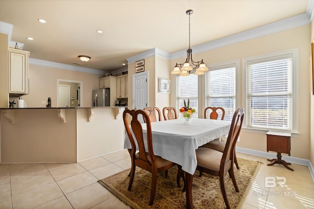 tiled dining area featuring ornamental molding and a notable chandelier