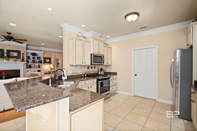 kitchen featuring kitchen peninsula, stainless steel appliances, light tile patterned flooring, ornamental molding, and sink