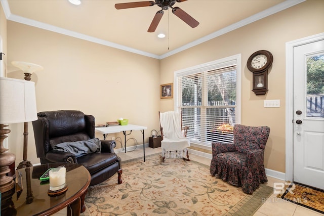 sitting room featuring ceiling fan, light tile patterned flooring, and crown molding