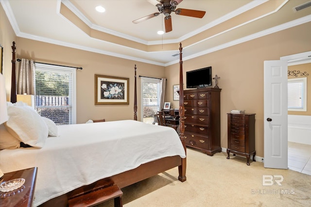 bedroom featuring light carpet, ceiling fan, crown molding, and a raised ceiling