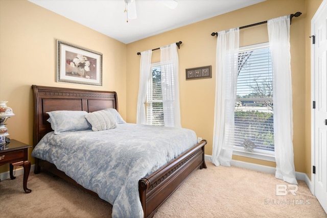 bedroom featuring ceiling fan and light colored carpet