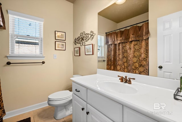 bathroom with toilet, tile patterned floors, and vanity