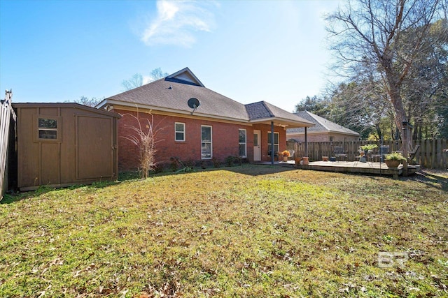 back of house with a lawn and a storage unit