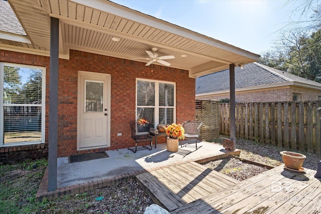 wooden terrace with ceiling fan and a patio area