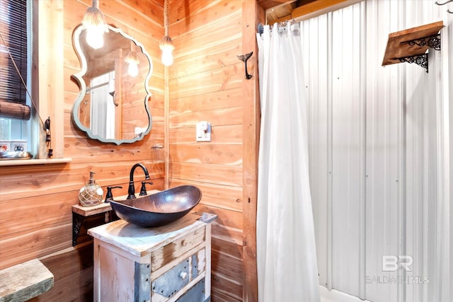 bathroom featuring hardwood / wood-style floors, vanity, and wooden walls