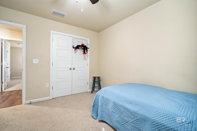 bedroom featuring a closet, ceiling fan, and carpet flooring