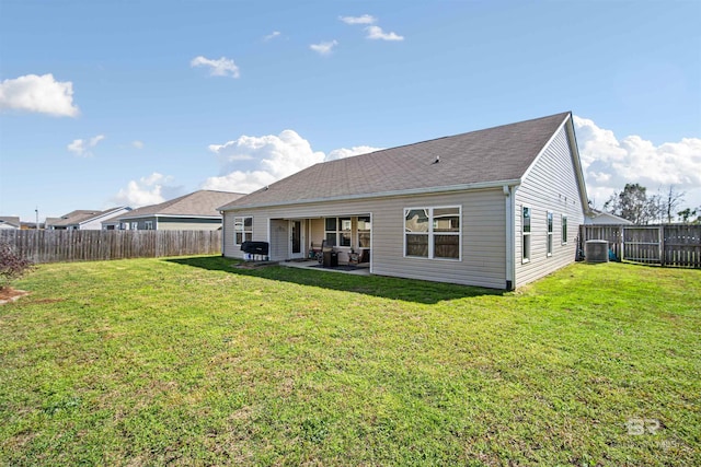 back of house featuring cooling unit, a patio, and a lawn