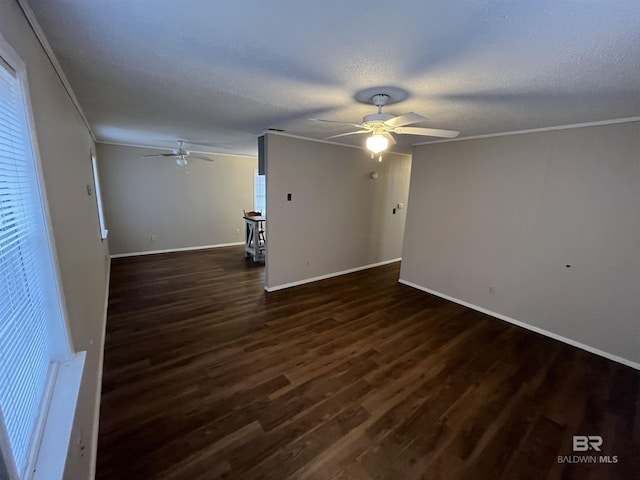 unfurnished living room with ornamental molding, a textured ceiling, ceiling fan, and dark hardwood / wood-style flooring