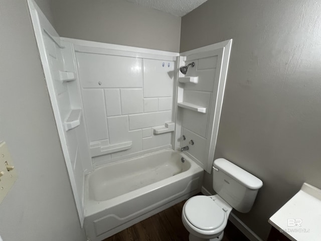 bathroom featuring toilet, a textured ceiling, bathtub / shower combination, and hardwood / wood-style floors