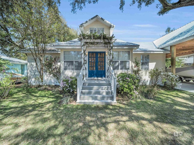 5410 Florida Ave, Orange Beach, AL 36561 - view of front of home with metal roof, french doors, and a front yard