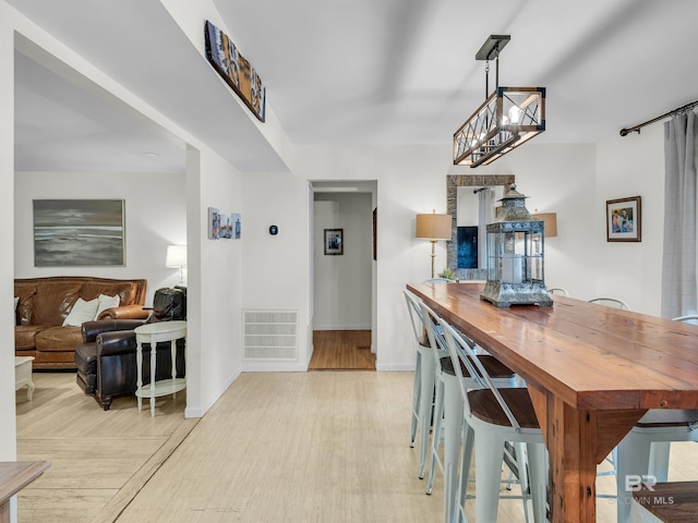 5410 Florida Ave, Orange Beach, AL 36561 - dining room featuring baseboards, visible vents, and light wood-style floors