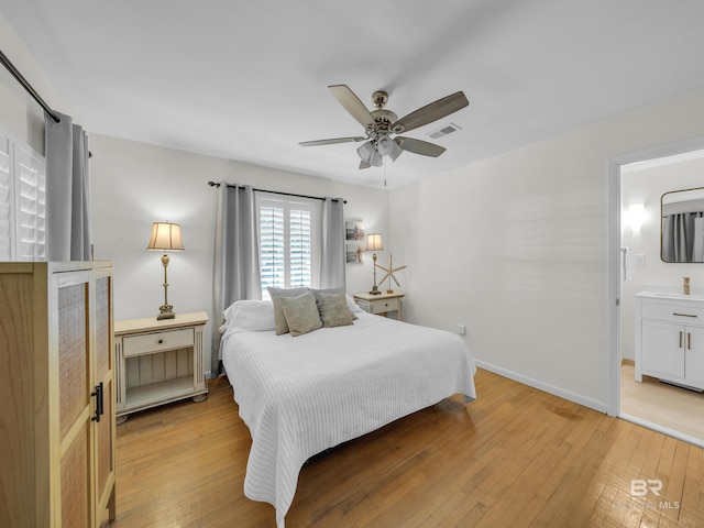 5410 Florida Ave, Orange Beach, AL 36561 - bedroom with baseboards, connected bathroom, light wood finished floors, visible vents, and a ceiling fan