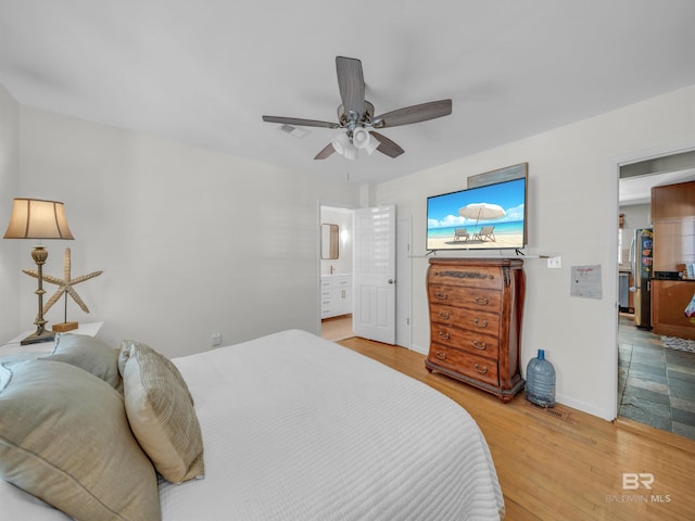 5410 Florida Ave, Orange Beach, AL 36561 - bedroom featuring visible vents, wood finished floors, a ceiling fan, and freestanding refrigerator