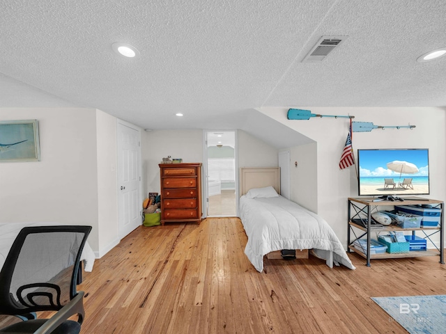 5410 Florida Ave, Orange Beach, AL 36561 - bedroom with a textured ceiling, visible vents, baseboards, recessed lighting, and light wood-type flooring