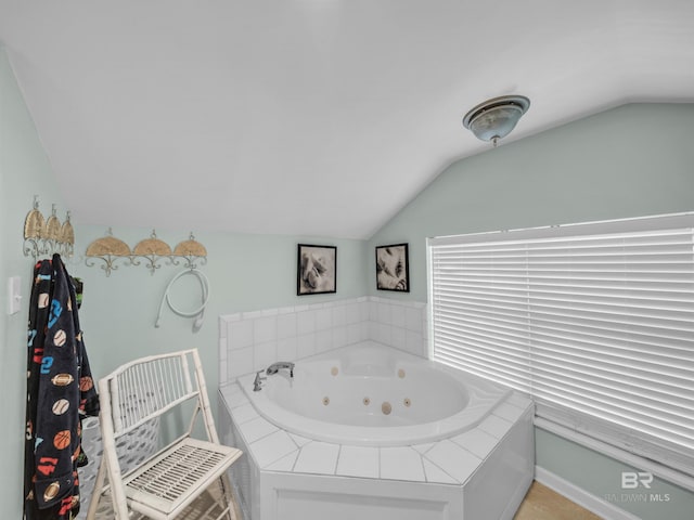 5410 Florida Ave, Orange Beach, AL 36561 - bathroom featuring a tub with jets and lofted ceiling