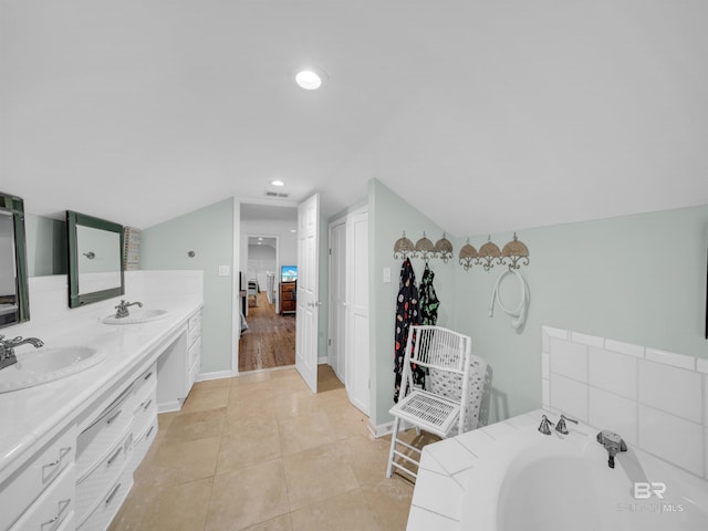 5410 Florida Ave, Orange Beach, AL 36561 - bathroom with double vanity, vaulted ceiling, a sink, and tile patterned floors