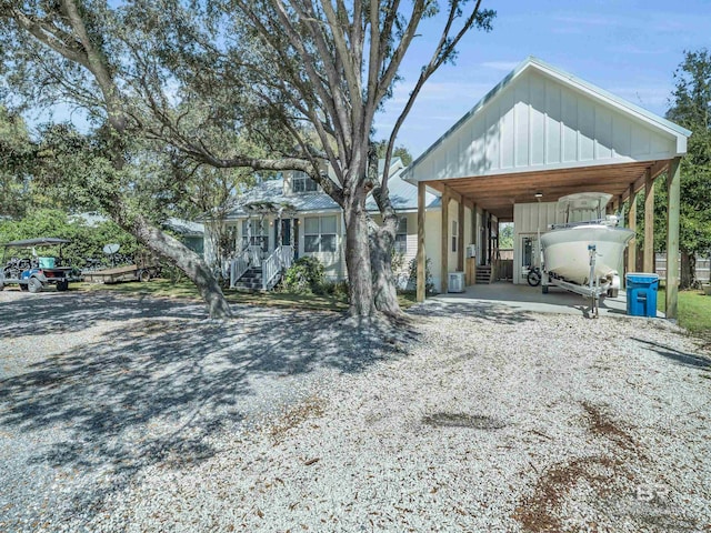 5410 Florida Ave, Orange Beach, AL 36561 - view of front facade featuring driveway, a detached carport, and board and batten siding