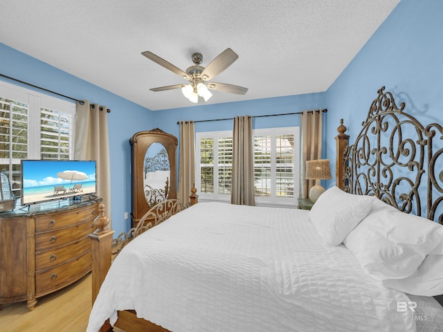 5410 Florida Ave, Orange Beach, AL 36561 - bedroom featuring wood finished floors, ceiling fan, and a textured ceiling