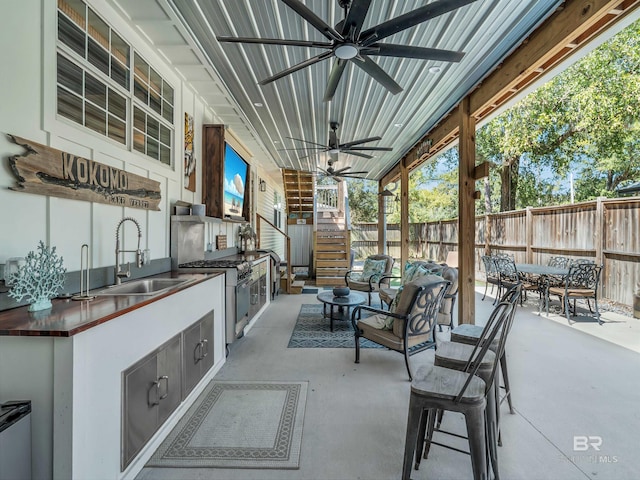 5410 Florida Ave, Orange Beach, AL 36561 - view of patio / terrace featuring stairway, fence, a sink, and area for grilling