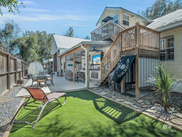 5410 Florida Ave, Orange Beach, AL 36561 - back of house with an outdoor structure, a shed, stairway, a patio, and a fenced backyard