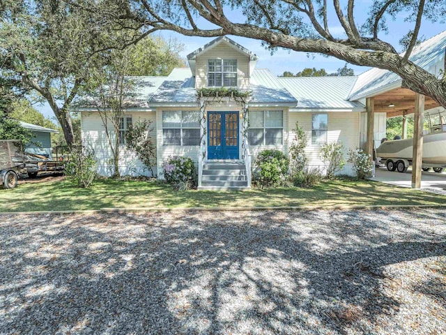 5410 Florida Ave, Orange Beach, AL 36561 - view of front of home featuring an attached carport, a front lawn, and french doors