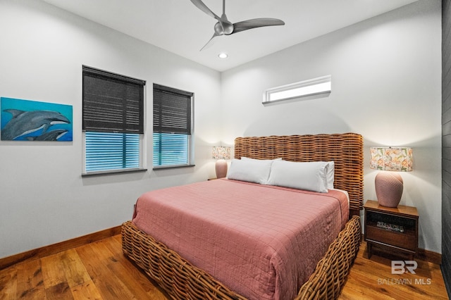 bedroom with recessed lighting, wood finished floors, a ceiling fan, and baseboards