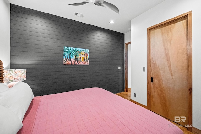 bedroom with visible vents, baseboards, ceiling fan, an accent wall, and recessed lighting