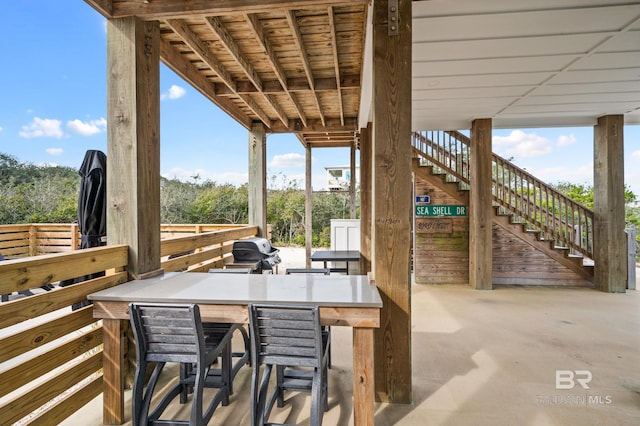 view of patio / terrace with stairs and outdoor dry bar