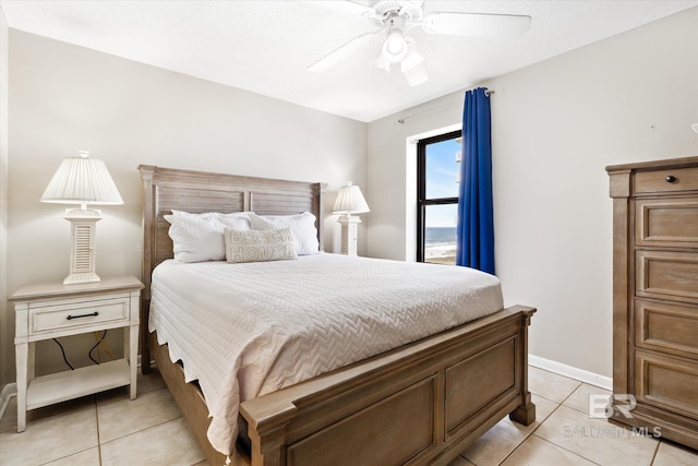 tiled bedroom featuring ceiling fan