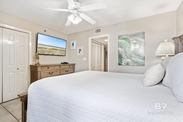 tiled bedroom with ceiling fan