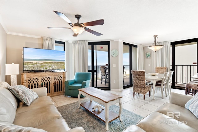 tiled living room featuring plenty of natural light, ceiling fan, expansive windows, and ornamental molding