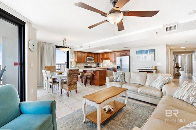 living room with ceiling fan and light tile flooring