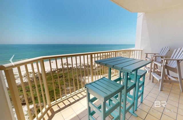 balcony featuring a beach view and a water view