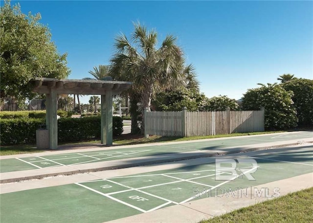 surrounding community featuring shuffleboard and fence