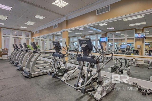 workout area with crown molding, a paneled ceiling, and visible vents