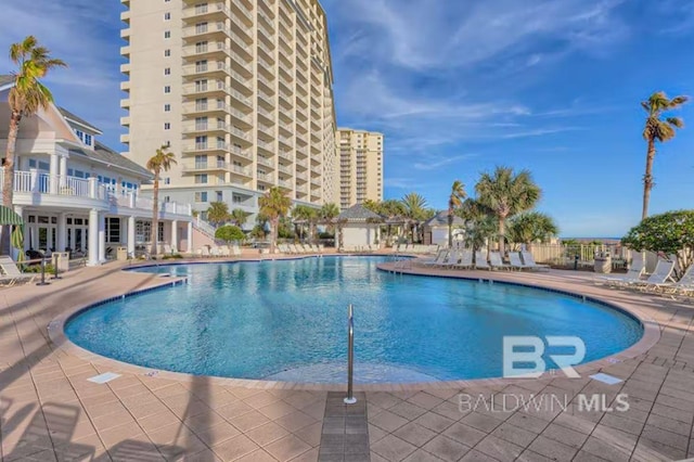 community pool with a patio area