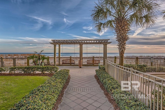 view of property's community with a water view and fence