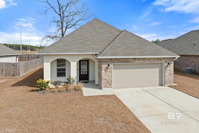 view of front of house featuring central AC and a garage