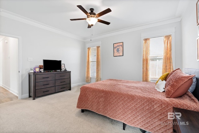 bedroom with crown molding, light colored carpet, and ceiling fan