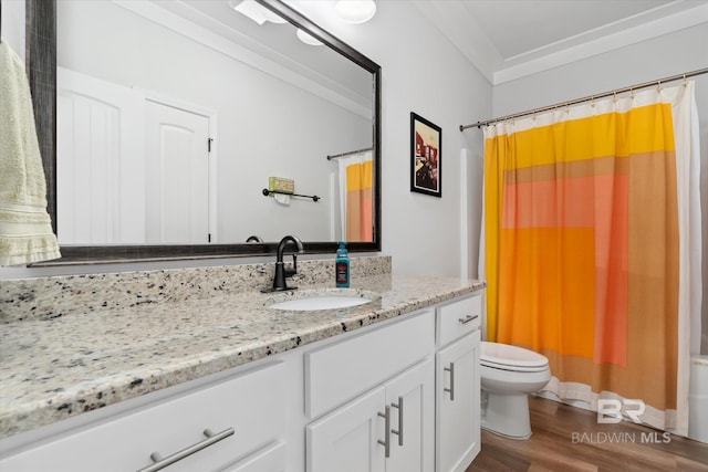 full bathroom featuring toilet, shower / tub combo, ornamental molding, vanity, and hardwood / wood-style flooring