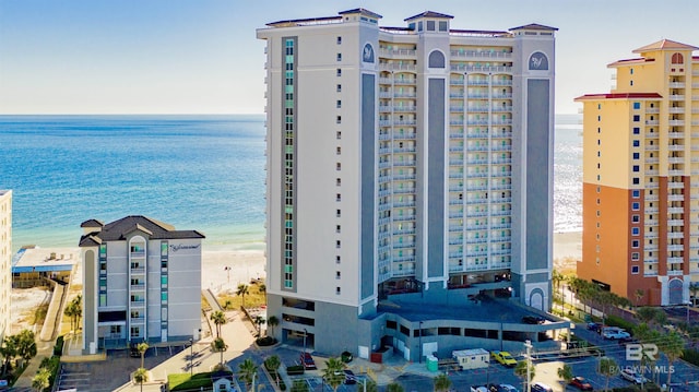 view of property with a water view and a beach view