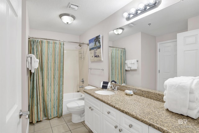 full bathroom with a textured ceiling, vanity, shower / bath combo with shower curtain, tile patterned flooring, and toilet