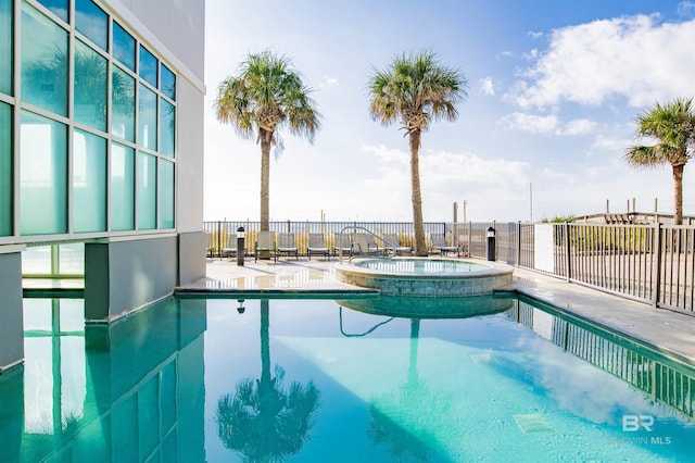 view of pool featuring a community hot tub and a patio