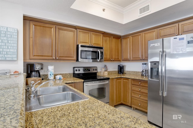 kitchen featuring light stone counters, stainless steel appliances, crown molding, sink, and light tile patterned flooring