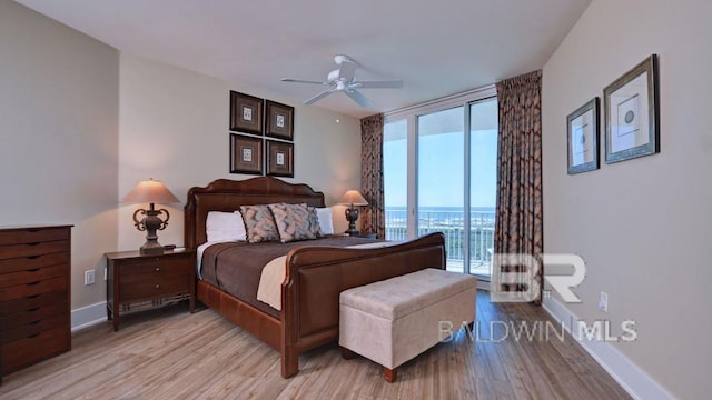 28107 Perdido Beach Blvd Unit D615, Orange Beach, AL 36561 - bedroom featuring expansive windows, light wood-style floors, access to exterior, baseboards, and a ceiling fan