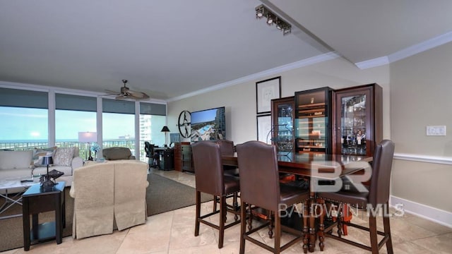 28107 Perdido Beach Blvd Unit D615, Orange Beach, AL 36561 - dining room featuring crown molding, a ceiling fan, light tile patterned flooring, and baseboards