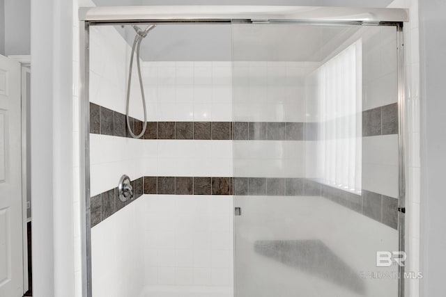 bathroom with a shower with shower door